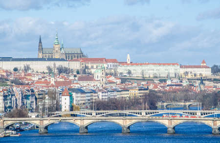 prague castle is hidden behind many bridges on vltava / moldau river when looked from the vysehrad castle.のeditorial素材