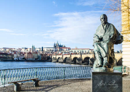 statue of composer bedrich smetana with prague castle and charles bridge behind it.のeditorial素材