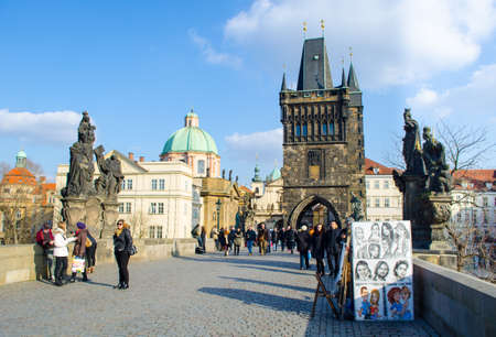 PRAGUE, CZECH REPUBLIC, JANUARY 30, 2015: People are walking over the famous charles bridge in...