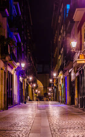 Night view of a narrow street of the old town of Bilbao, Spain
の写真素材