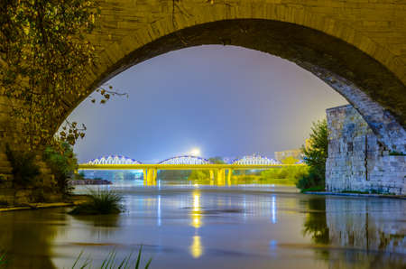 Night view of the puente de piedra and puente de pilar in the spanish city Zaragoza
の写真素材