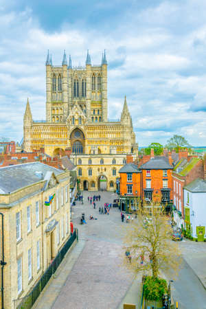 People are walking on a square in front of the Lincoln cathedral, Englandのeditorial素材