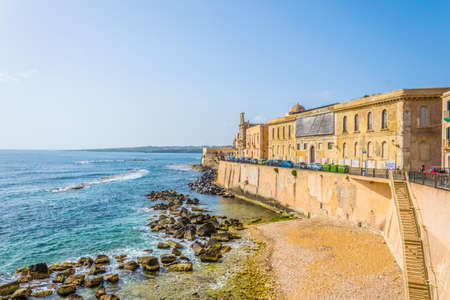 View of the seaside promenade surrounding the old town of Syracuse in Sicily, Italyの写真素材