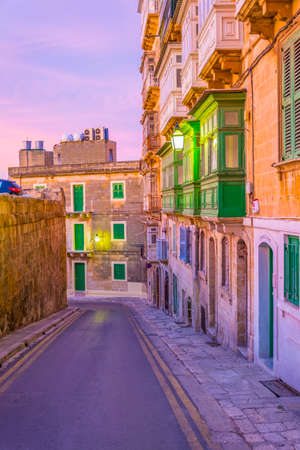 Sunset view of a narrow street in the historical center of Valletta, Malta