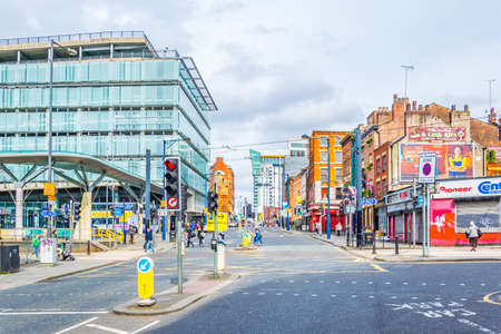 MANCHESTER, UNITED KINGDOM, APRIL 11, 2017: People are walking on a street in Manchester, Englandのeditorial素材