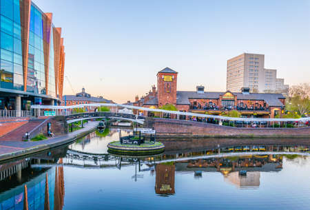 BIRMINGHAM, UNITED KINGDOM, APRIL 8, 2017: Sunset view of a restaurant alongside a water channel in...