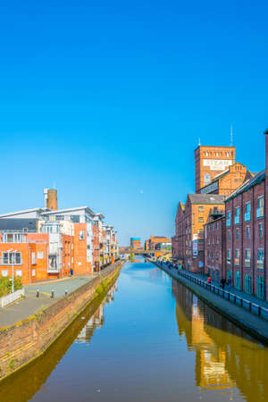 CHESTER, UNITED KINGDOM, APRIL 7, 2017: View of buildings alongside a channel going through the center of Chester, Englandのeditorial素材