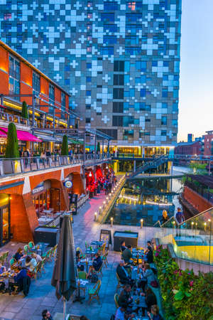 BIRMINGHAM, UNITED KINGDOM, APRIL 8, 2017: Sunset view of a restaurant alongside a water channel in...