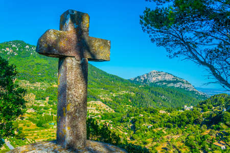 A cross with Serra Tramuntana mountain range at background, Mallorca, Spainの写真素材