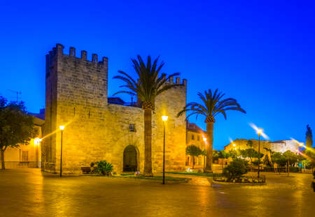 Sunset view of Porta del moll leading to the old town of Alcudia, Mallorca, Spainのeditorial素材