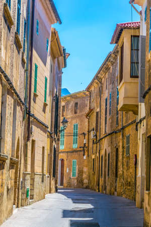 View of a narrow street in the old town of Pollenca, Mallorca, Spainの写真素材