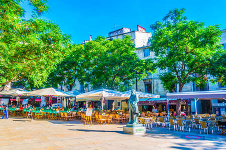 MONTPELLIER, FRANCE, JUNE 26, 2017: People are sitting at restaurants at Place jean Jaures in the...