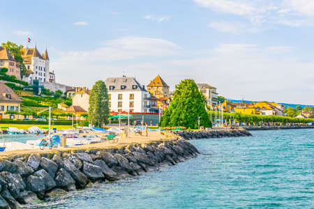 White Palace in Nyon viewed behind marina in Nyon, Switzerland