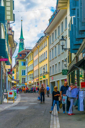 SOLOTHURN, SWITZERLAND, JULY 15, 2017: People are strolling through a narrow street in the...