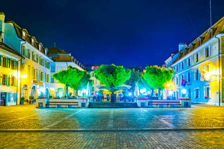 NYON, SWITZERLAND, JULY 19, 2017: Night view of a restaurant on a square in front of the Chateau de Nyon in Switzerlandのeditorial素材