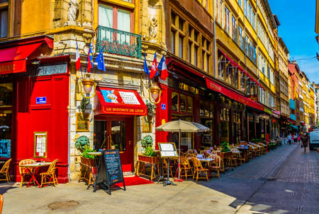 LYON, FRANCE, JULY 22, 2017: a narrow street full of restaurants is waiting for first customers to come, Lyon, Franceのeditorial素材