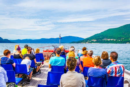 CANNOBIO, ITALY, JULY 27, 2017: Tourists sitting on an upper deck of a ferry travelling on Lago Maggiore in Italyのeditorial素材