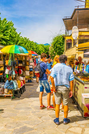 ISOLA BELLA, ITALY, JULY 27, 2017: People are walking through a narrow street at Isola Bella at Lago...