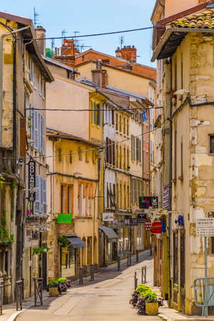 VIENNE, FRANCE, JULY 23, 2017: People are strolling a narrow street in the historical center of...