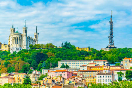 La Basilique Notre Dame de Fourviere and metallic tower in the french city Lyonの写真素材