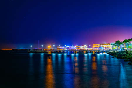 Night view of Molos promenade with several piers leading to the mediterranean sea in Limassol,...