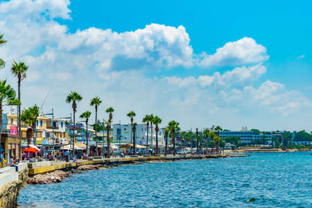 PAPHOS, CYPRUS, AUGUST 18, 2017: People are enjoying a sunny day on a seaside promenade in Paphos, Cyprusのeditorial素材
