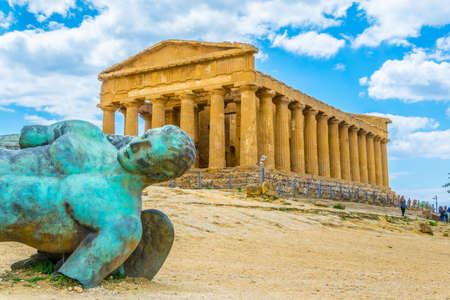 Statue of fallen Icaro in front of the Concordia temple in the Valley of temples near Agrigento in Sicily, Italyの写真素材