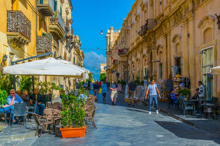 NOTO, ITALY, APRIL 25, 2017: People are strolling on the corso Vittorio Emanuele in Noto, Sicily, Italyのeditorial素材