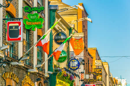 DUBLIN, IRELAND, MAY 9, 2017: Colourful shields on a busy street in the central Dublin, Irelandのeditorial素材