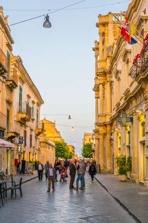 NOTO, ITALY, APRIL 25, 2017: People are strolling on the corso Vittorio Emanuele in Noto, Sicily, Italyのeditorial素材