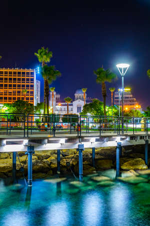 Night view of Molos promenade with several piers leading to the mediterranean sea in Limassol, Cyprusの写真素材