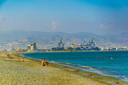LIMASSOL, CYPRUS, AUGUST 17, 2017: Limassol viewed behind people swimming at Lady's mile beach on cyprusのeditorial素材