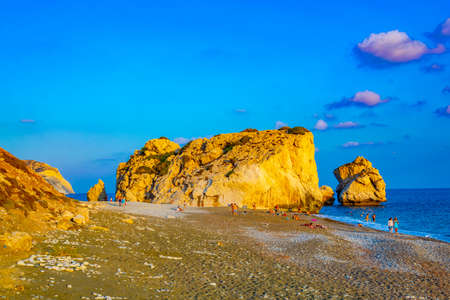 PAPHOS, CYPRUS, AUGUST 20, 2017: People are enjoying sunset view over Petra tou Romiou alas Aphordite's rock on Cyprusのeditorial素材