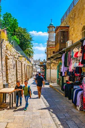JERUSALEM, ISRAEL, SEPTEMBER 6, 2018: People are strolling among various shops situated in a narrow...