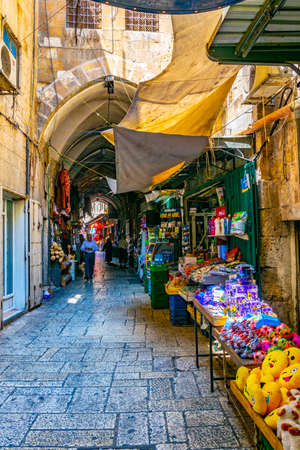 JERUSALEM, ISRAEL, SEPTEMBER 6, 2018: People are strolling among various shops situated in a narrow street in the old town of Jerusalem, Israelのeditorial素材