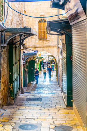 JERUSALEM, ISRAEL, SEPTEMBER 8, 2018: People are strolling among various shops situated in a narrow street in the old town of Jerusalem, Israelのeditorial素材