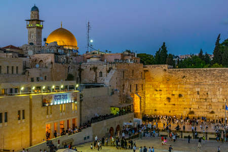 JERUSALEM, ISRAEL, SEPTEMBER 8, 2018: Sunset view of people are praying at the western wall in the...