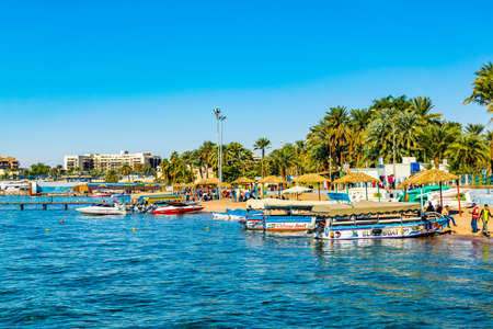 AQABA, JORDAN, DECEMBER 31, 2018: Glass-bottom boats mooring at a beach in Aqaba, Jordan