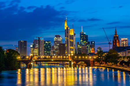 Skyscrapers reflected on the river Main in Frankfurt, Germanyの写真素材