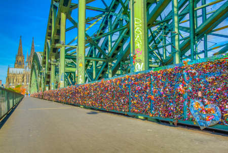 Detail of love locks on Hohenzollern bridge in Cologne with the cathedral at background, Germanyのeditorial素材