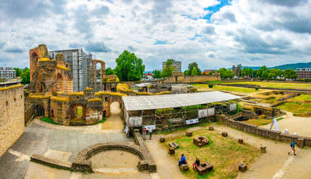 TRIER, GERMANY, AUGUST 14, 2018: People strolling through ruins of Kaiserthermen in Trier, Germany
