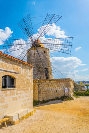 View of a windmill in the Saline di Trapani e Paceco natural reserve near Trapani, Sicily, Italyのeditorial素材