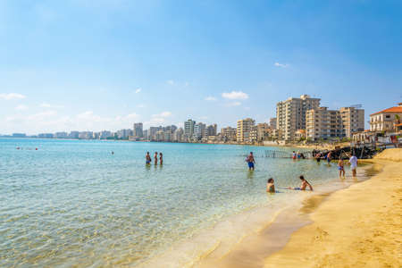 FAMAGUSTA, CYPRUS, AUGUST 29, 2017: People are enjoying a sunny day on a beach in front of Varosia...