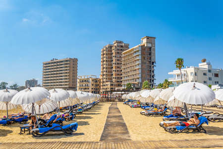 FAMAGUSTA, CYPRUS, AUGUST 29, 2017: People are enjoying a sunny day on a beach in front of Varosia district of Famagusta, Cyprusのeditorial素材