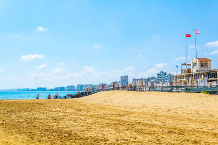 FAMAGUSTA, CYPRUS, AUGUST 29, 2017: People are enjoying a sunny day on a beach in front of Varosia district of Famagusta, Cyprusのeditorial素材