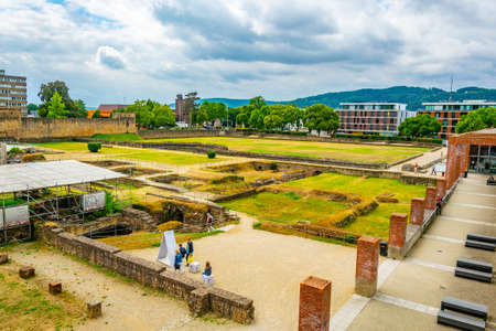 TRIER, GERMANY, AUGUST 14, 2018: People strolling through ruins of Kaiserthermen in Trier, Germany