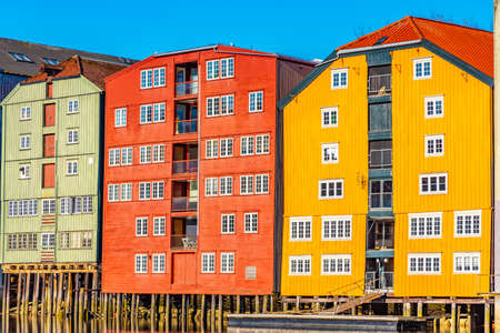 Colorful timber houses surrounding river Nidelva in the Brygge district of Trondheim, Norway