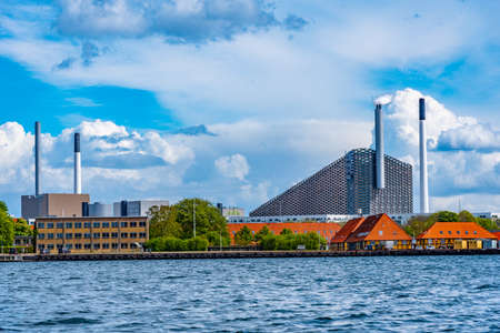 View of Amager Bakke factory with skiing slope on the rooftop in Copenhagen, Denmark