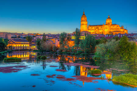 Sunset view of Cathedral at Salamanca reflected on river Tormes, Spainの写真素材