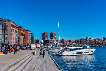 OSLO, NORWAY, APRIL 15, 2019: Town hall in oslo viewed behind Stranden waterfront, Norwayの写真素材
